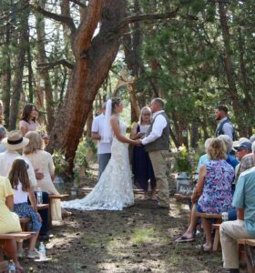 couple getting married in the forest at sundance trail guest ranch