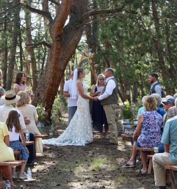 couple getting married in the forest at sundance trail guest ranch